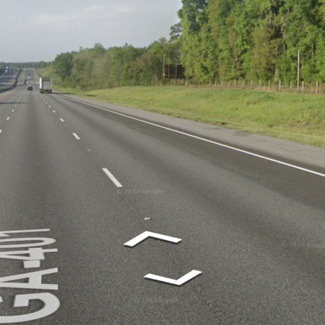 a road with trees and grass